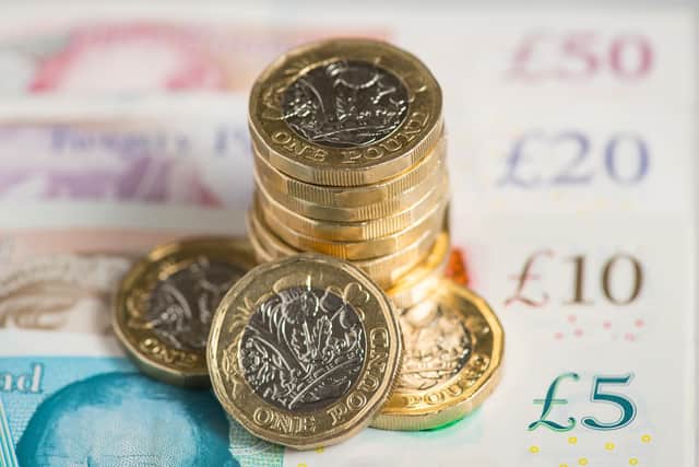 UK five pound, ten pound, twenty pound and fifty pound notes with one pound coins, as around 1.7 million workers will get a "significant" pay boost when the national minimum wage (NLW) increases from Saturday. A 92p rise to £10.42 an hour for workers aged 23 and over is equivalent to a near 10% increase, the Resolution Foundation said.