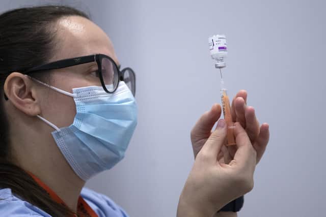 A member of the Vaccination Team prepares a vaccine at the coronavirus mass vaccine centre at the Edinburgh International Conference Centre.