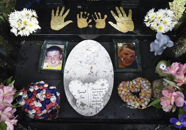 Gary Amos and his daughter Rosie at grave of Adam Amos his dead son