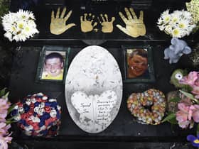 Gary Amos and his daughter Rosie at grave of Adam Amos his dead son