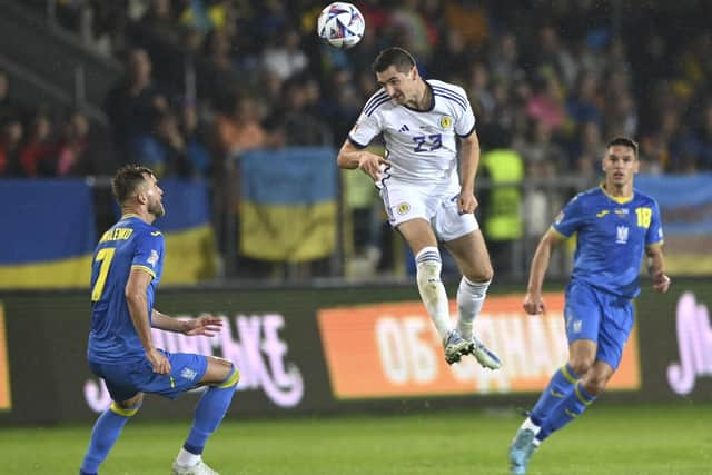 Scotland's Kenny McLean heads the ball ahead of Ukraine's Andriy Yarmolenko in Krakow.