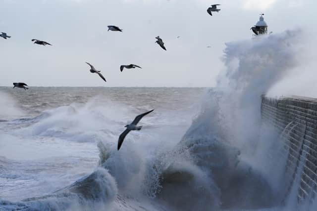 Waves crash against a pier wall at Tynemouth on the north east coast of England as Storm Bella sweeps across the UK. Picture: Owen Humphreys/PA Wire.