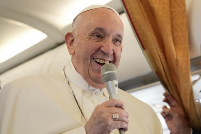 Pope Francis greets journalists aboard an airplane on his way to Hungary (AP Photo/Gregorio Borgia, Pool)