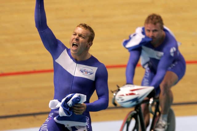 Scotland's Chris Hoy, left, celebrates after winning the cycling track men's team sprint final at the Commonwealth Games in Melbourne, Australia, Sunday, March 19, 2006. At background is his teammate Craig Maclean. (AP Photo/Alastair Grant)