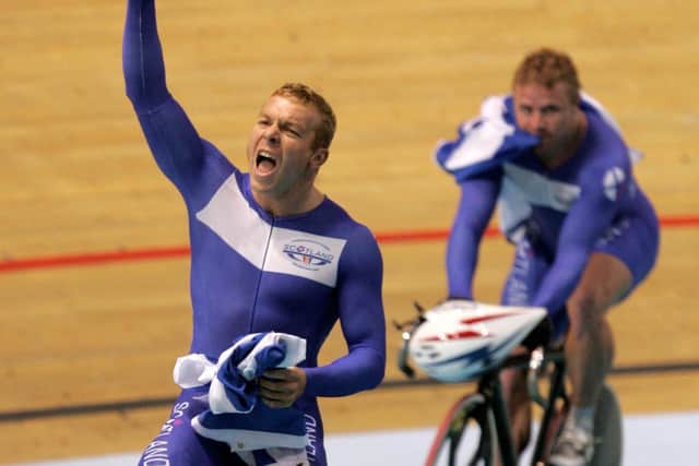 Scotland's Chris Hoy, left,  celebrates  after winning the cycling track  men's team sprint final at the Commonwealth Games in Melbourne, Australia, Sunday, March 19, 2006. At background is his teammate Craig Maclean.  (AP Photo/Alastair Grant)