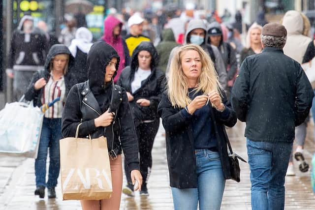 Pedestrians on Edinburgh's Princes Street. (Photo by LESLEY MARTIN/AFP via Getty Images)