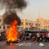 The biggest wave of social unrest in Iran in almost three years has seen protesters chant 'Woman, Life, Freedom' and 'down with the dictator' (Picture: AFP via Getty Images)