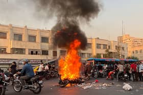 The biggest wave of social unrest in Iran in almost three years has seen protesters chant 'Woman, Life, Freedom' and 'down with the dictator' (Picture: AFP via Getty Images)