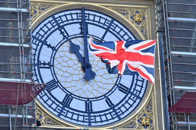 The clock face of Elizabeth Tower, known after the bell Big Ben, shows the hands at 11 o'clock as a Union Flag flies in front of it in London. Picture Justin Tallis/AFP via Getty Images