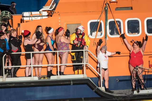 ​The intrepid swimmers get ready to take to the waters at Fraserbugh Harbour. Pic: RNLI