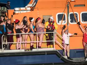 ​The intrepid swimmers get ready to take to the waters at Fraserbugh Harbour. Pic: RNLI