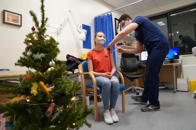 A person receives a Covid-19 vaccination as a 24-hour "jabathon" takes place at an overnight walk-in vaccine clinic at the Morris House GP practice in Haringey. Picture date: Friday December 17, 2021.