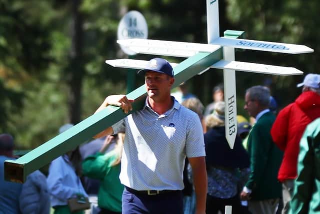 Bryson DeChambeau moves a sign while preparing to play his second shot on the 13th hole from the 14th fairway during the second round of the 2024 Masters. Picture: Photo by Maddie Meyer/Getty Images.