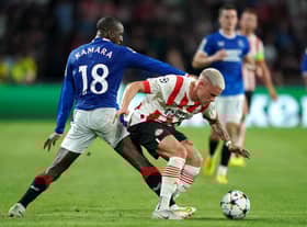 Rangers' Glen Kamara (left) and PSV Eindhoven's Philipp Max battle for the ball.