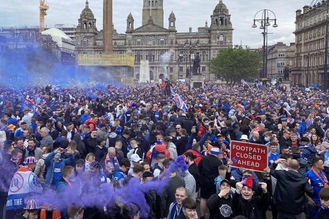 Rangers fans celebrate winning the Scottish Premiership title at George Square, Glasgow.