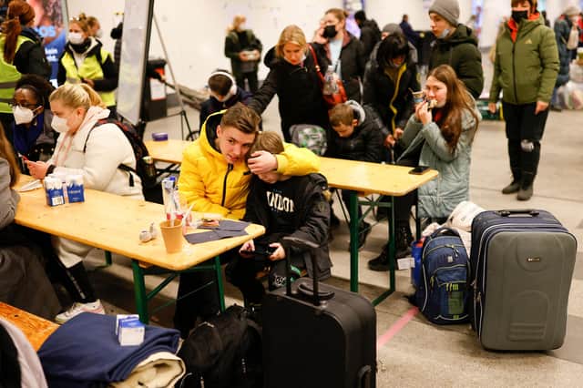 Young Ukrainian refugees rest after arriving at the main railway station in Berlin on Monday (Picture: Odd Andersen/AFP via Getty Images)