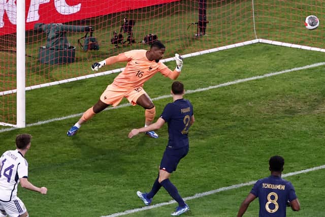 Billy Gilmour curls the ball past Mike Maignan to put Scotland ahead against France.