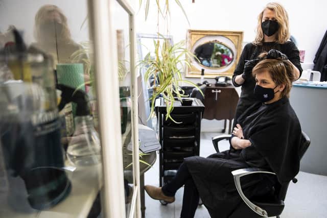 First Minister Nicola Sturgeon, wears a face covering, as she has her hair coloured and cut by Julie McGuire at Beehive Hair and Make up hairdressers' salon in Edinburgh, during campaigning for the Scottish Parliamentary election. Picture: Andy Buchanan/PA Wire