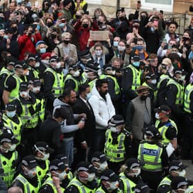 Two men are released from the back of an Immigration Enforcement van accompanied by lawyer Aamer Anwar and Mohammad Asif, director of the Afghan Human Rights Foundation, in Kenmure Street, Glasgow which is surrounded by protesters.