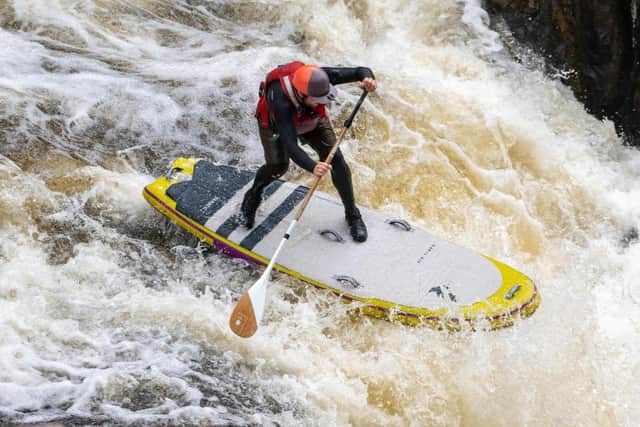 Sam Garthwaite white water paddle boarding. (Photo by Silviu Dascalu)