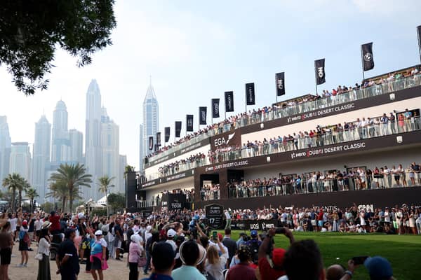 A huge crowd watches Rory McIlroy tee off on the 17th hole during the final round of the Hero Dubai Desert Classic at Emirates Golf Club on Sunday. Picture: Warren Little/Getty Images.