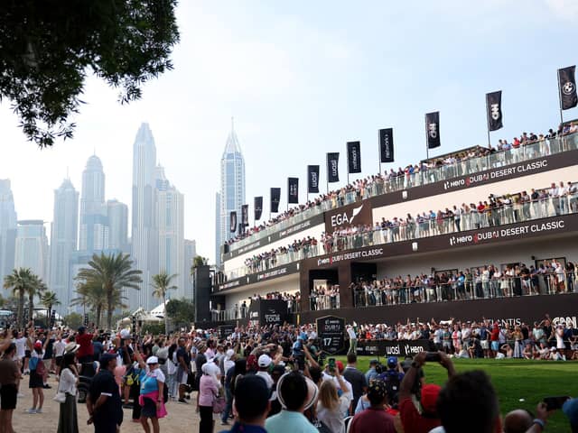 A huge crowd watches Rory McIlroy tee off on the 17th hole during the final round of the Hero Dubai Desert Classic at Emirates Golf Club on Sunday. Picture: Warren Little/Getty Images.