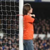 A fan ties himself to the net in protest during the Premier League match between Everton and Newcastle United at Goodison Park on March 17, 2022 in Liverpool, England. (Photo by Michael Regan/Getty Images)