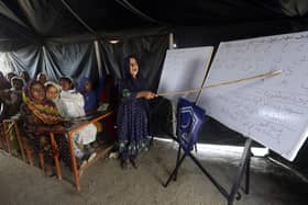 Flood affected children attend makeshift school organized by Islamic group Jamaat-e-Islami Pakistan, in Sukkur, Pakista. (AP Photo/Fareed Khan, File)