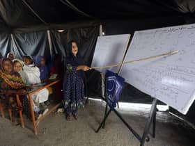 Flood affected children attend makeshift school organized by Islamic group Jamaat-e-Islami Pakistan, in Sukkur, Pakista. (AP Photo/Fareed Khan, File)