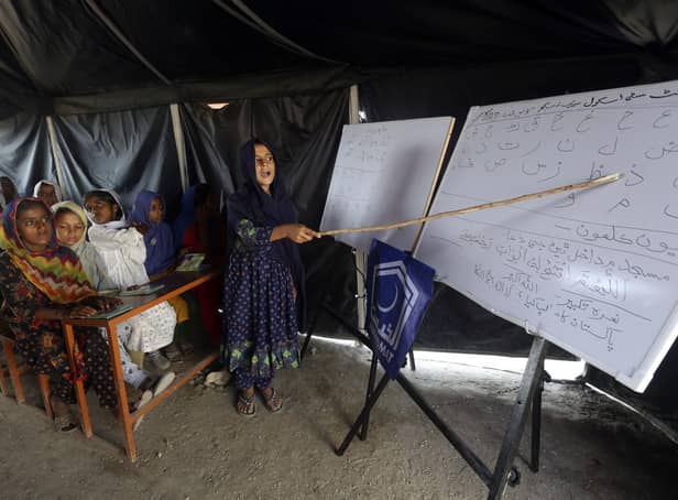 Flood affected children attend makeshift school organized by Islamic group Jamaat-e-Islami Pakistan, in Sukkur, Pakista. (AP Photo/Fareed Khan, File)