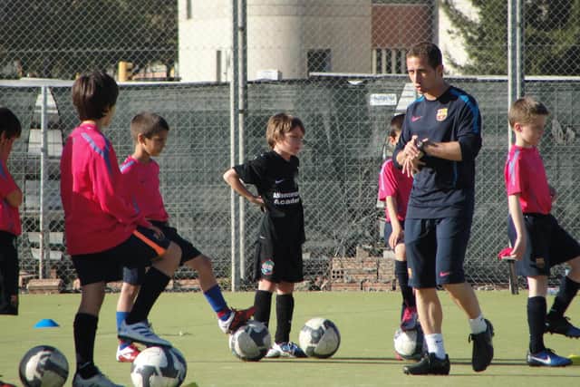 An eight-year-old Archie Meekison, centre in black, training with Barcelona in the shadow of Camp Nou.