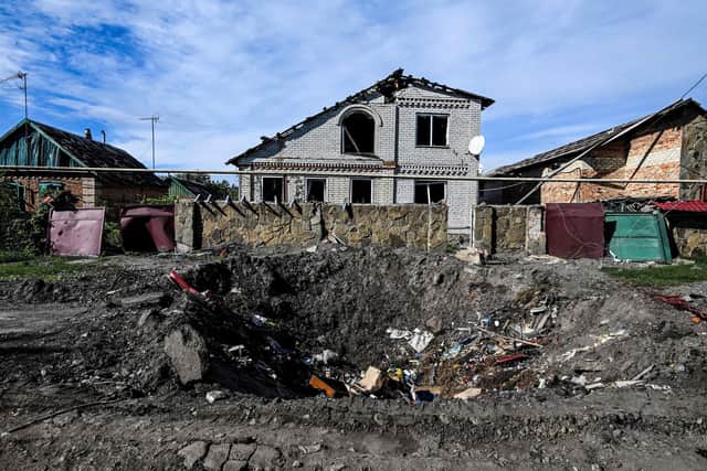 A photo shows damaged houses and a crater in the ground in Siversk, Donetsk region amid Russia's military invasion on on Ukraine. Picture: Juan Barreto/AFP via Getty Images