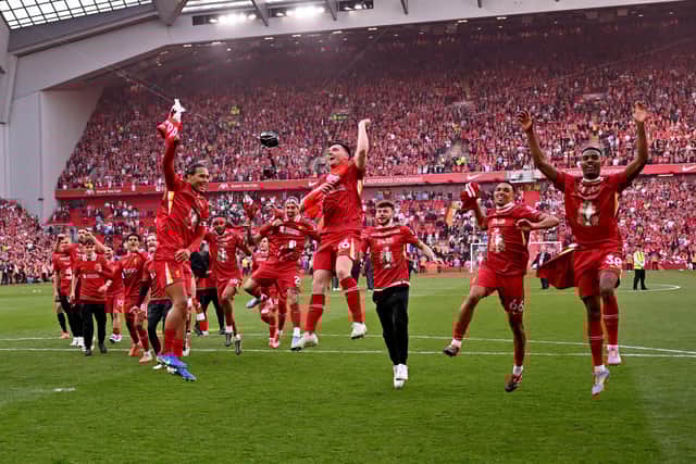 Andy Robertson celebrates Liverpool’s title win on Sunday,