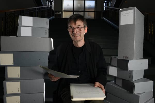 Scottish crime writer Ian Rankin, holding his 1984 manuscript for his first published novel Flood, with some of the 50 boxes of his own personal archive which he is donating to the National Library of Scotland, Edinburgh (SWNS)