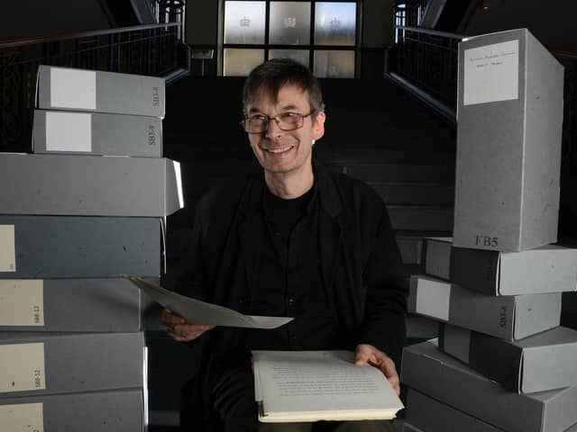 Scottish crime writer Ian Rankin, holding his 1984 manuscript for his first published novel Flood, with some of the 50 boxes of his own personal archive which he is donating to the National Library of Scotland, Edinburgh (SWNS)