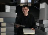 Scottish crime writer Ian Rankin, holding his 1984 manuscript for his first published novel Flood, with some of the 50 boxes of his own personal archive which he is donating to the National Library of Scotland, Edinburgh (SWNS)