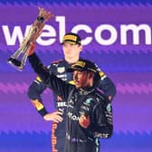 Lewis Hamilton lifts the Saudi Arabia Grand Prix trophy as second-placed Max Verstappen looks on (Photo by GIUSEPPE CACACE/AFP via Getty Images)