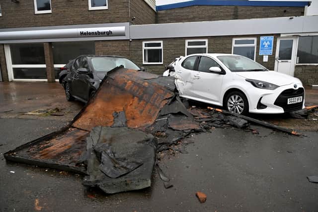 Cars damaged by a falling roof outside a dealership in Helensburgh after storm Eowyn brought gusts of up to 100mph in January (Picture: Andy Buchanan/AFP via Getty)