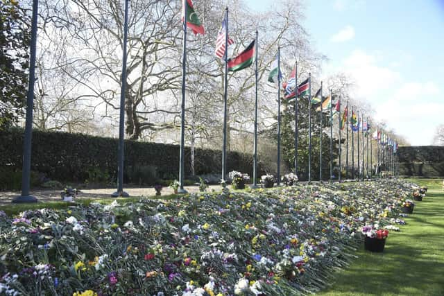 The flowers, tributes and messages left by members of the public outside Buckingham Palace following the death of Prince Philip are on display in the gardens of Marlborough House, London, Thursday April 15, 2021. (Jeremy Selwyn/Pool via AP)