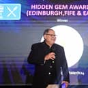 Luis Letelier-Lobos accepts the 'Hidden Gem' award on behalf on Midlothian curry house The Radhuni from event host Katy Johnston.