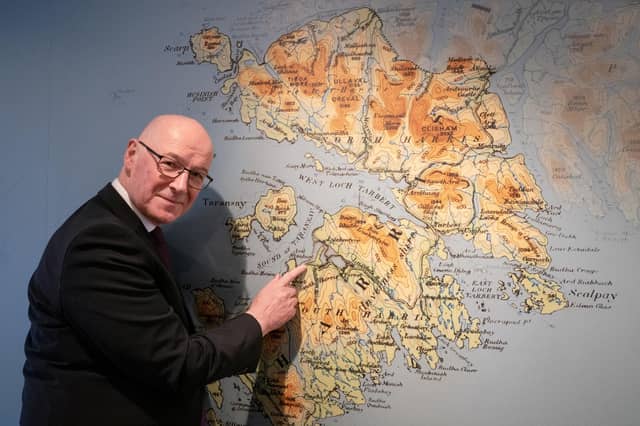 John Swinney takes a look at a map of the Isle of Harris during a visit to the Isle of Harris Distillery in Tarbert