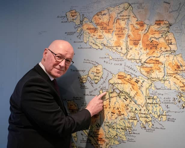 John Swinney takes a look at a map of the Isle of Harris during a visit to the Isle of Harris Distillery in Tarbert
