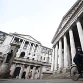 A woman cycling past the Bank of England and the Royal Exchange in the City of London. Picture: Kirsty O'Connor/PA Wire