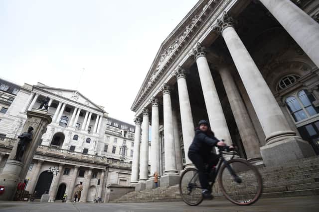 A woman cycling past the Bank of England and the Royal Exchange in the City of London. Picture: Kirsty O'Connor/PA Wire