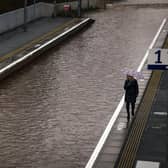 A member of the public is seen on the platform of Bowling station, which is shut by flooding. Picture: Jeff J Mitchell/Getty Images