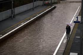 A member of the public is seen on the platform of Bowling station, which is shut by flooding. Picture: Jeff J Mitchell/Getty Images