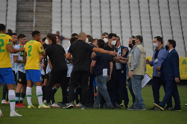 Health authorities enter to the field during the South American qualification football match for the FIFA World Cup Qatar 2022 (Photo by NELSON ALMEIDA/AFP via Getty Images)