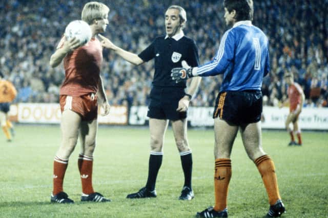 Aberdeen's Frank McDougall (left) is spoken to by referee Bob Valentine as Dundee Utd goalkeeper Hamish McAlpine watches on during the Skol Cup semi-final 2nd leg in 1985.