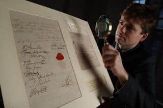 Lyon & Turnbull Specialist Dominic Somerville-Brown with the rare manuscript signed by Lord Nelson, his lover and his lover's husband. PIC: Stewart Attwood.