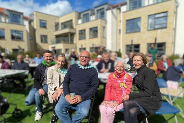 A resident and their family at Cramond's charity event